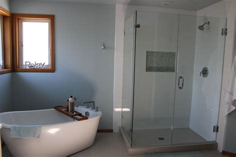 This inviting bathroom features a glass shower enclosure with a step up to a freestanding tub. Master bath update with freestanding tub and glass shower ...