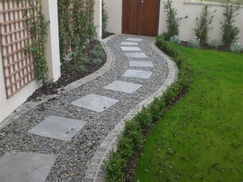 Build a new paver patio. Square Paving Stones In A Curving Gravel Path A Lawn I ...