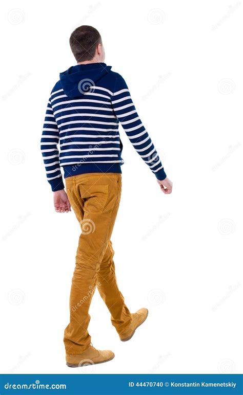 Back View Of Walking Handsome Man In Jeans And Striped Sweater Stock
