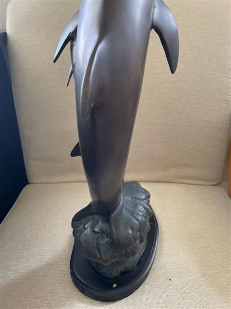 I Have A Bronze Mother Dolphin With Baby Statue It Has No Markings On