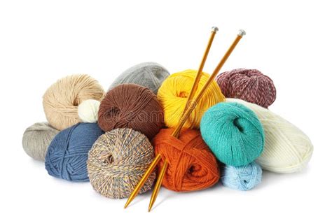 Different Balls Of Woolen Knitting Yarns And Needles On White