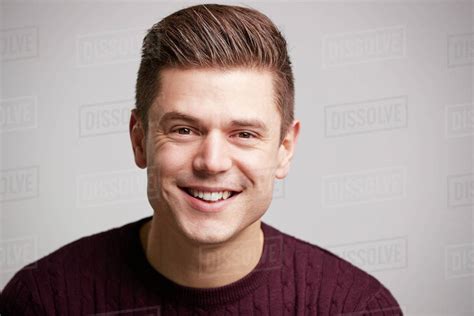 Portrait Of A Smiling Young White Man Looking To Camera Stock Photo