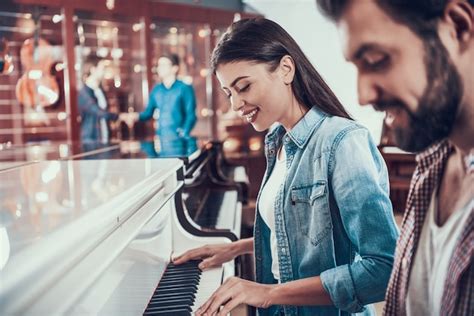 Premium Photo Beautiful Young Couple Playing Piano Together In Music