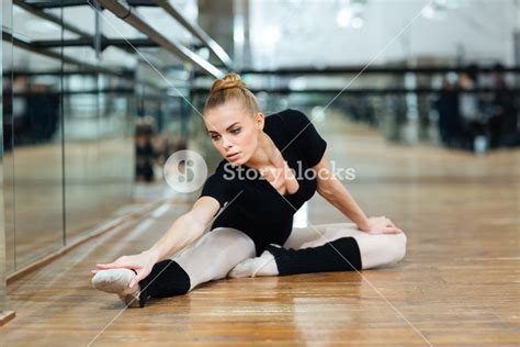 Lovely Ballerina Doing Stretching Exercises In Ballet Class Royalty