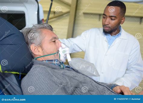 Male Patient On Stretcher Wearing Oxygen Mask Stock Image Image Of