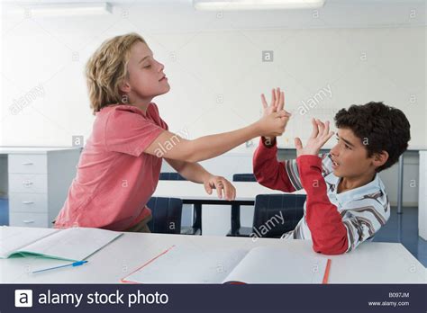 School Boys 10 13 In Classroom Fighting One Boy Hitting The Other