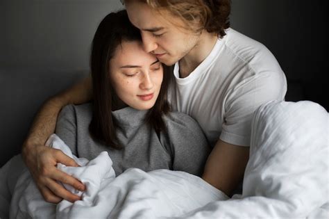 free photo affectionate couple cuddling in bed