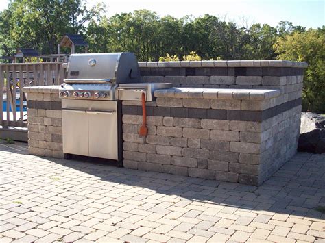 Outdoor kitchens have become an extremely popular outdoor extra for new homes, especially in warmer climates. Landscape Construction LLC - Grill / Outdoor Kitchen