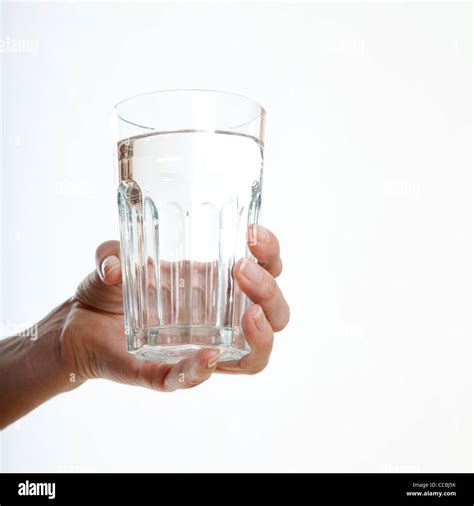 Womans Hand Holding Glass Of Water Stock Photo Alamy