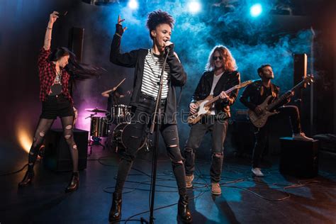 Female Singer With Microphone And Rock And Roll Band