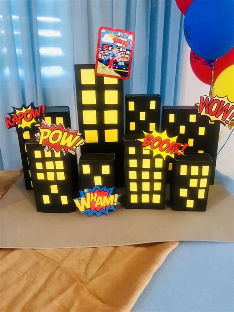 A Table Topped With Black And Yellow Boxes Filled With Comic Book