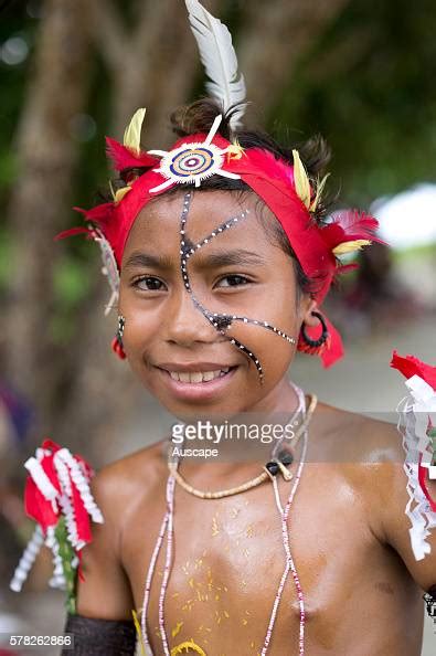 A Young Girl With Red Headband Decorated With A Feather Kitava
