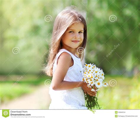 Summer Portrait Of Little Girl With Flowers Stock Photo