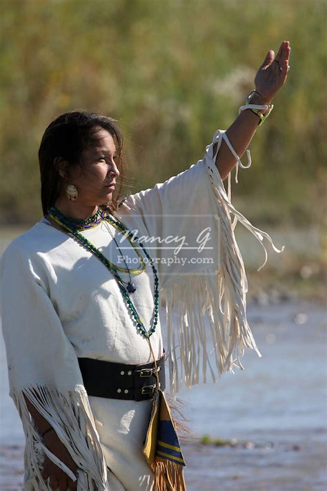 A Native American Indian Women Worshiping The Sun While Standing In The River In South Dakota