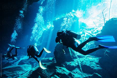 Scuba Divers Diving In An Underwater Cave In A Cenote In Yucatán