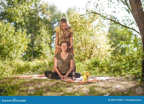 healer applies her massage skills on her client on the grass stock image image of patient