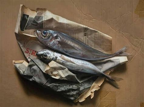 Two Fish Are Laying On Top Of Some Newspaper
