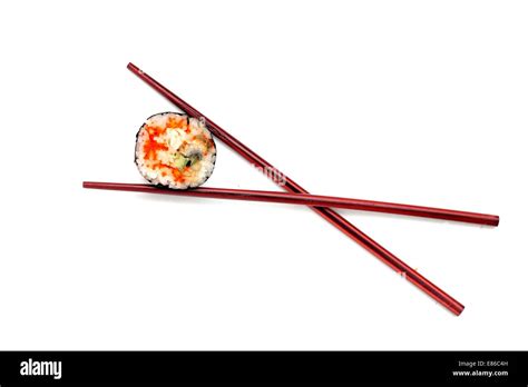 Single Japan Sushi Roll In The Chopsticks Isolated Stock Photo Alamy