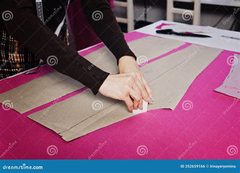 Female Fashion Designer Tailor Making Sewing Patterns At Workplace In