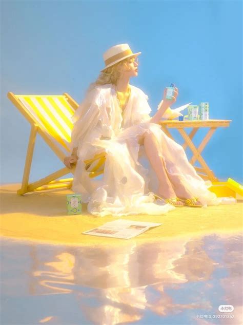 A Woman Sitting On Top Of A Yellow Beach Chair Next To A Blue Sky And Water