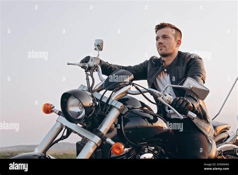 Stylish Young Attractive Guy Is Sitting On A Motorcycle A Handsome