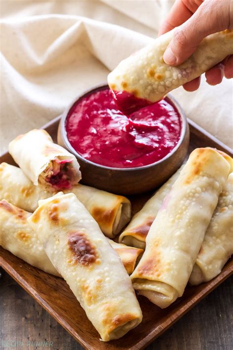 1 cup turkey or ham, 1 cup mashed potatoes, 1 cup stuffing, 1 packages egg roll wraps (can be found in produce section at store), 1 egg (to brush wrap with), 1 cup cranberry jelly, 1/3 cup apple cider vinegar (regular vinegar is fine), 1/2 cup sugar, 1 vegetable oil. Turkey, Cranberry and Brie Egg Rolls - Recipe Runner