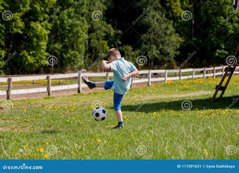 Boy Plays Soccer In A A Blue Shirt Stock Image Image Of Football