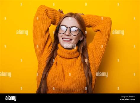Close Up Portrait Of Ginger Caucasian Lady With Freckles Wearing Eyeglasses And Posing With