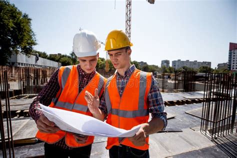 Structural Engineer And Construction Manager Dressed In Orange Work