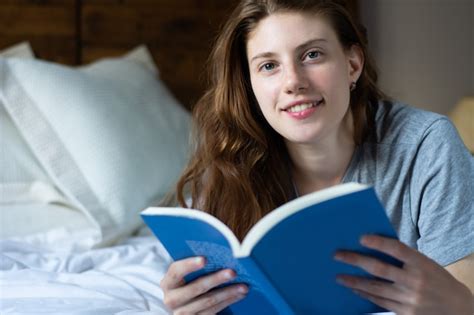 Premium Photo Woman Laying In Bed And Reading Book