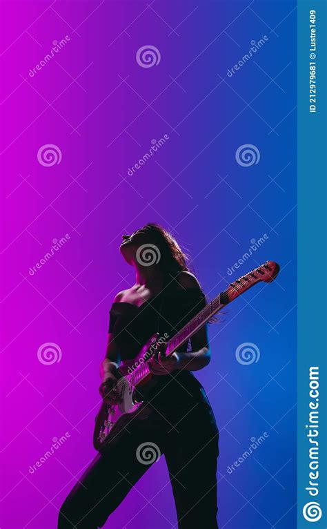 Silhouette Of Young Female Guitarist Isolated On Gradient Background In