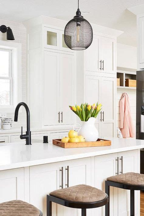 Simple to clean, this handcrafted sink is breathtaking in all facets. An oil rubbed bronze faucet paired with a farm sink is fitted to a white kitchen isla… | White ...