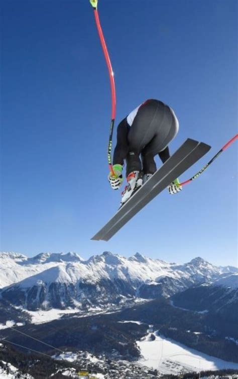 A Man Flying Through The Air While Riding Skis