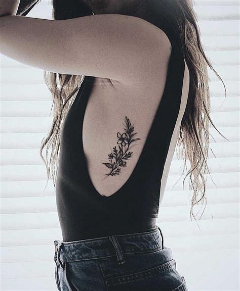A Black Floral Piece On The Left Rib Cage By Stella Rib Tattoos For