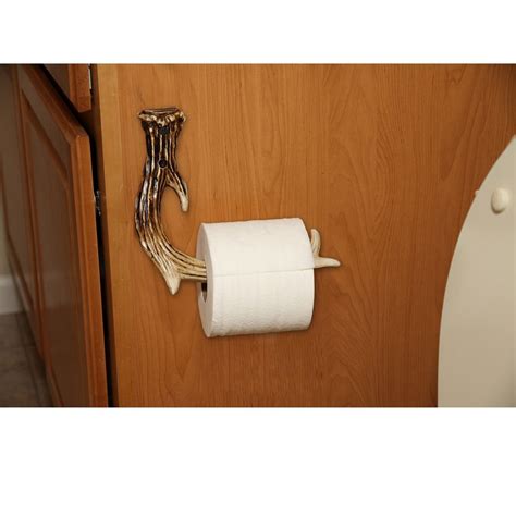 A Toilet Paper Roll Hanging On The Wall Next To A Wooden Cabinet With