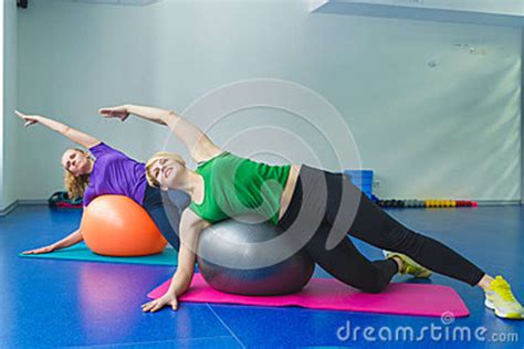 Two Young Sporty Women Doing Gymnastic Exercises Or Exercising In