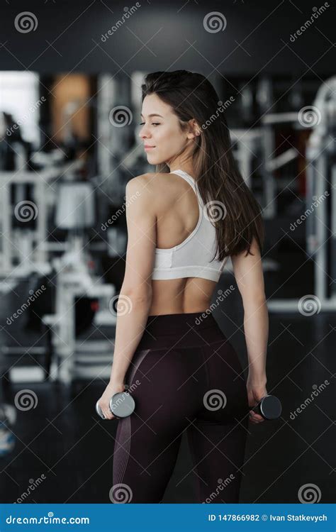 Sport Athletic Fitness Woman Pumping Up Muscles With Dumbbells Stock
