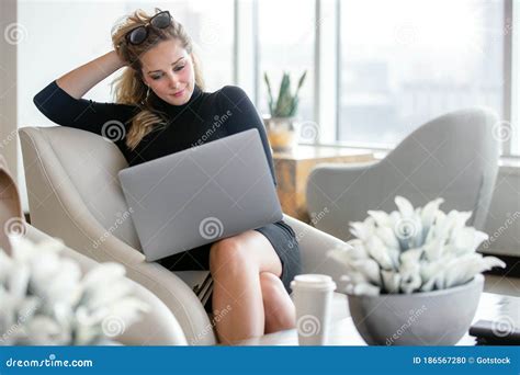 Elegant Stylish And Classy Business Woman Working From Computer In Luxury Office Interior