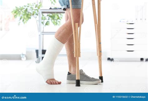 Man With Broken Leg In Cast Standing On Crutches Stock Photo Image Of