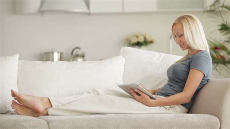 Pretty Girl Sitting On Couch Using Touchpad Stock Footage Sbv 303984751