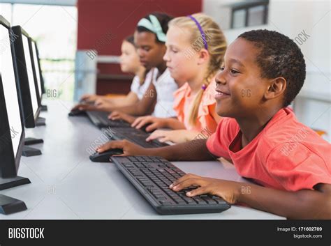 School Kids Using Computer In Classroom At School Stock Photo And Stock