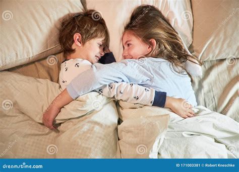 Brother And Sister Cuddle In Bed Stock Image Image Of Bedroom People 171003381