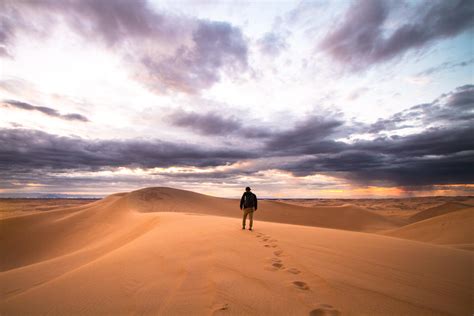Person Walks Alone Through The Desert Sands Of Glamis Unsplash