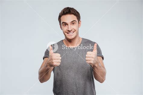 Portrait Of A Happy Smiling Man Showing Two Thumbs Up Isolated On The