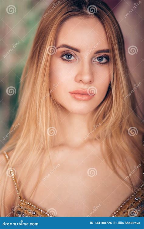 Close Up Portrait Of Young Blonde Woman With Bright Makeup Looking At