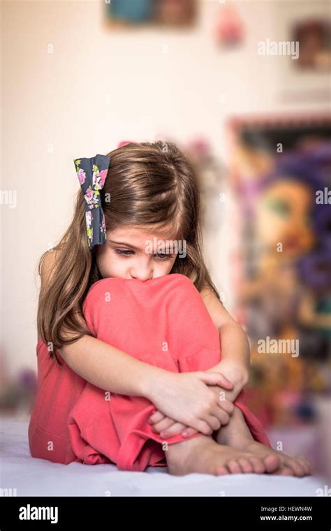 Sad Girl Hugging Knees Stock Photo Alamy