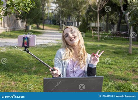 Female Blond Blogger Taking Selfie Photos With Her Stick Stock Image Image Of Adult Internet