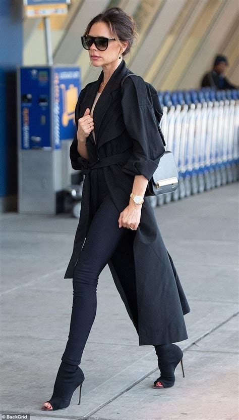 Victoria Beckham Prepares To Jet Off In A Chic Oversized Trench Coat And Leggings Daily Mail