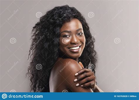 Portrait Of Nude Beautiful Afro Woman Smiling Over Grey Background