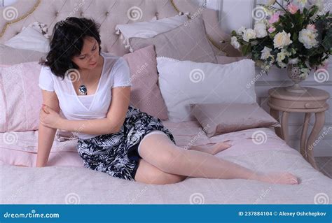 Beautiful Legged Brunette Girl In Miniskirt And White Stockings Posing